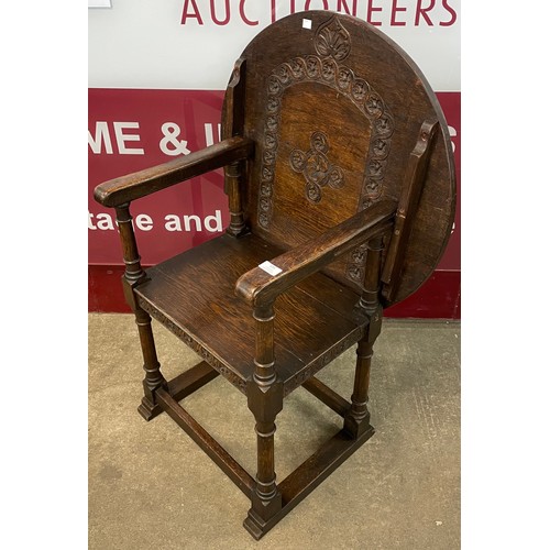 192 - An early 20th Century Jacobean Revival carved oak monks seat