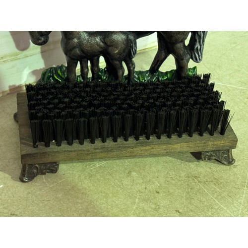 5150 - A cast metal horse and foal doorstop with shoe/boot brush* This lot is subject to VAT