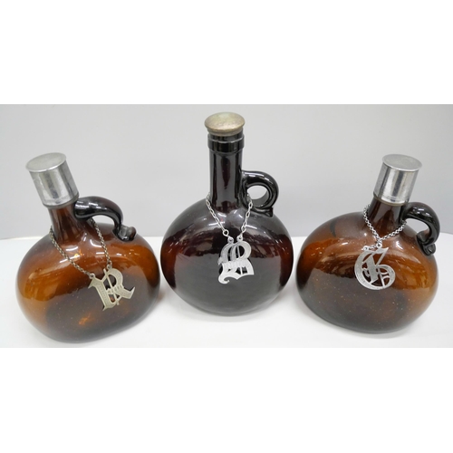 2001 - Three William IV amber glass onion decanters, with Gin, Ruby and Brandy spirit labels