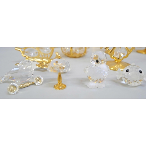 2043 - Ten small Swarovski crystal ornaments and other brass and crystal ornaments