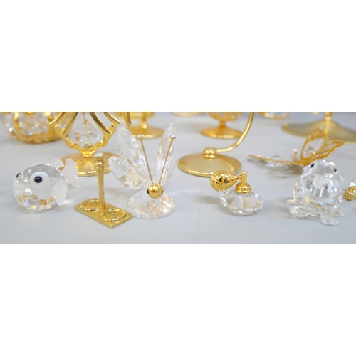 2043 - Ten small Swarovski crystal ornaments and other brass and crystal ornaments