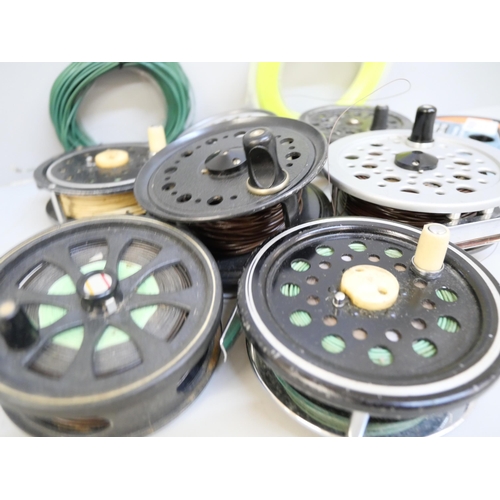 2067 - A collection of seven fly fishing reels and line