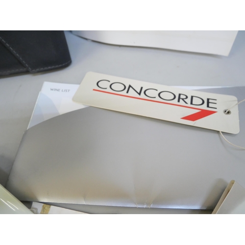 2072 - A collection of Concorde collectables, wallet, napkin rings, pen, stationery, tickets, menus, plasti... 