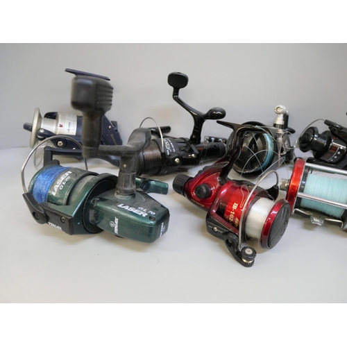 2107 - A collection of spinner fishing reels and spools of line, Daiwa, AVS, Okuma, Tenax and others