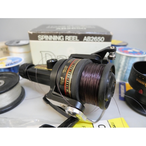 2107 - A collection of spinner fishing reels and spools of line, Daiwa, AVS, Okuma, Tenax and others