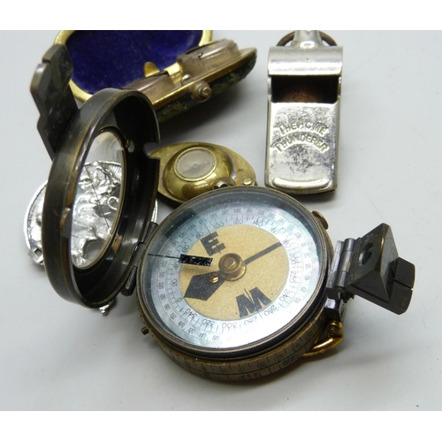 2165 - A pocket compass, Short & Mason, a double sovereign case, a magnifying glass with compass, a whistle... 