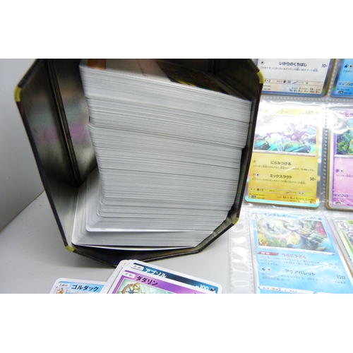 2182 - Over 500 Japanese Pokemon cards in tin with sleeved Holographic