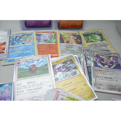 2183 - 500 + Japanese and English Pokemon cards in collectors tin including English Holographic with rare c... 