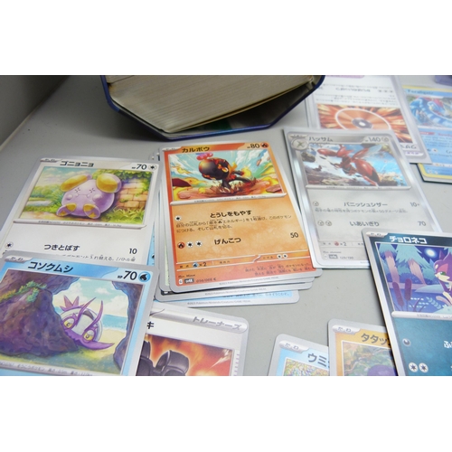 2183 - 500 + Japanese and English Pokemon cards in collectors tin including English Holographic with rare c... 