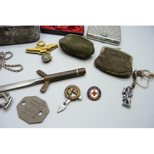 2195 - A collection of jewellery, military and other badges, purse with silver coins, compact, etc.