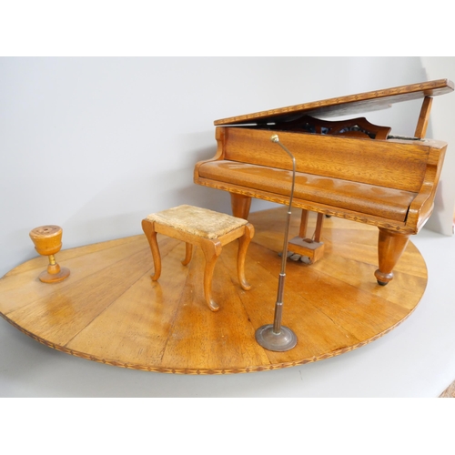 2221 - An inlaid musical box in the form of a Grand Piano on a wooden stage, with stool, microphone and smo... 