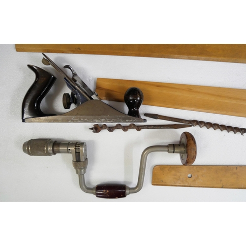 2232 - A collection of tools including draughtsman's T squares, Record No 4 wood plane and joiners brace wi... 