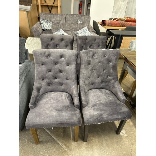 3206 - A set of four dark grey upholstered dining chairs  *This lot is subject to Vat