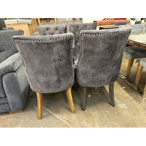 3206 - A set of four dark grey upholstered dining chairs  *This lot is subject to Vat