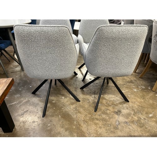 3233 - A set of 4 boucle dining chairs *This lot is subject to Vat