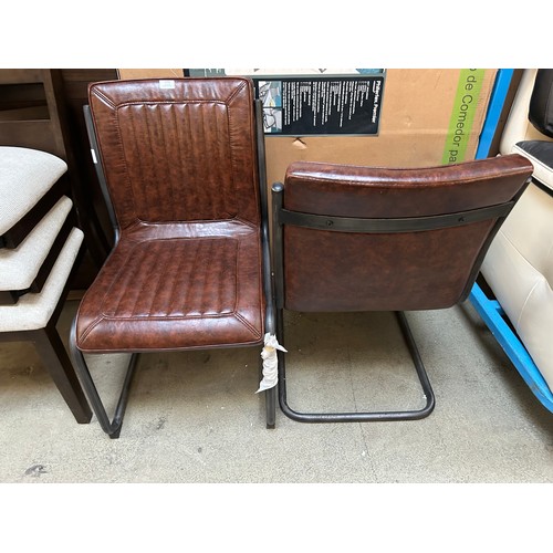 3316 - A pair of faux leather dining chairs (tear in fabric)  *This lot is subject to Vat