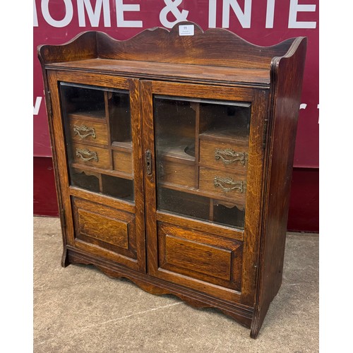 99 - A late Victorian oak smokers cabinet