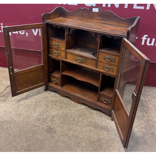 99 - A late Victorian oak smokers cabinet