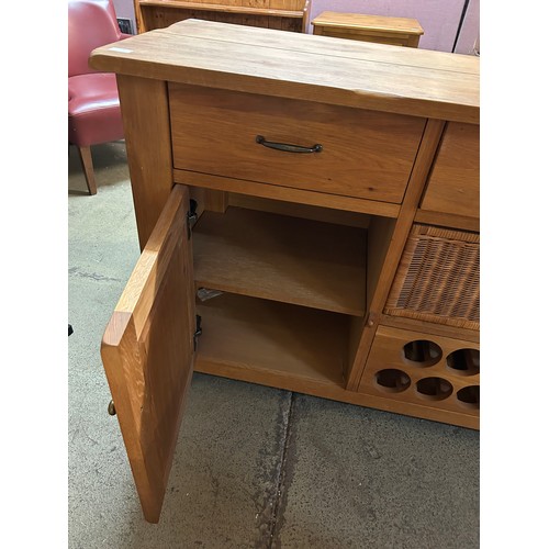 3287 - A solid oak 2 door 3 drawer sideboard with wine holder