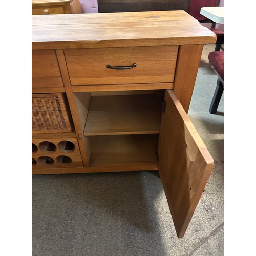 3287 - A solid oak 2 door 3 drawer sideboard with wine holder