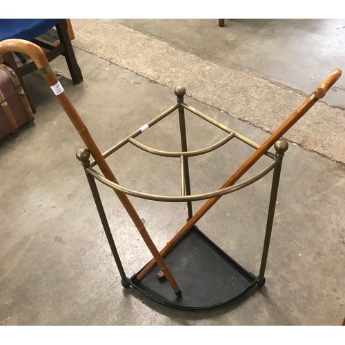 317 - A Regency style brass corner stickstand and two walking sticks