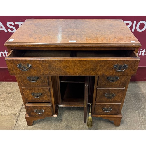 139 - A George II style burr walnut kneehole desk