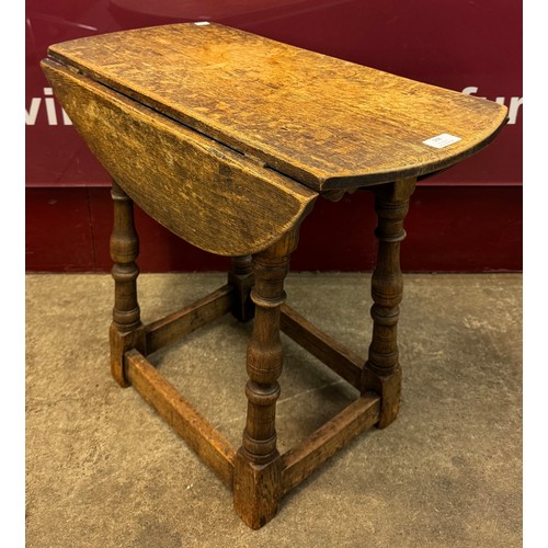 168 - An 18th Century style oak drop leaf occasional table