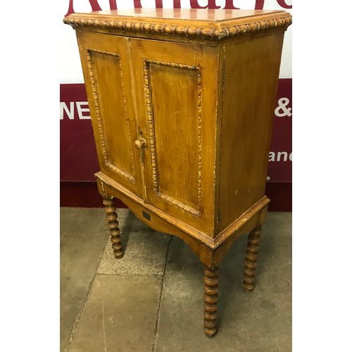 235 - A Victorian scrumbled pine two door cupboard