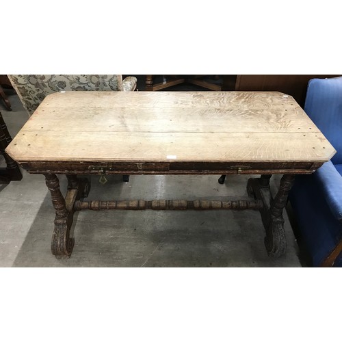 253 - A Victorian carved oak two drawer writing table