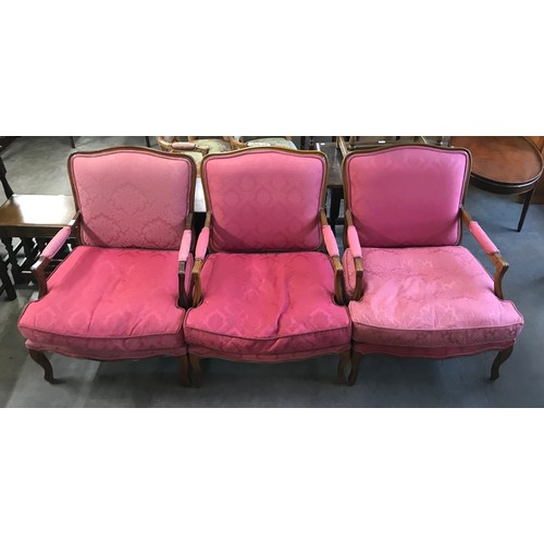 268 - A set of three French Louis XV style walnut and red fabric upholstered fauteuil chairs