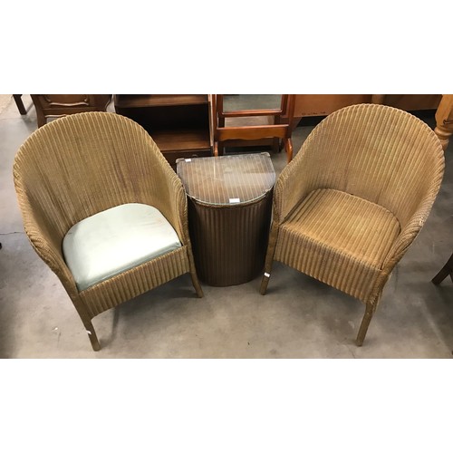 296 - A pair of Lloyd Loom wicker chairs an ottoman