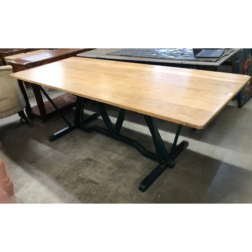 298 - A large industrial oak and cast metal based table