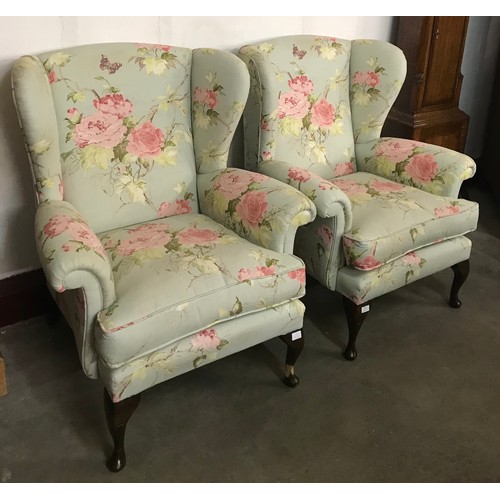 304 - A pair of Queen Anne style mahogany and fabric upholstered wingback armchairs