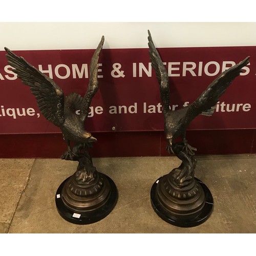 310 - A pair of French style bronze eagles on black marble socles