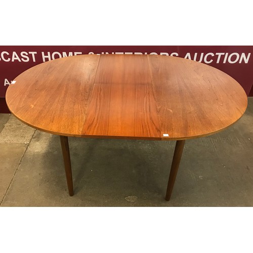 11 - A G-Plan teak circular extending dining table