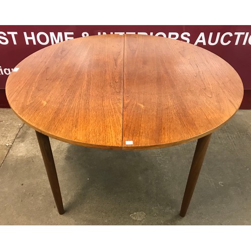 11 - A G-Plan teak circular extending dining table