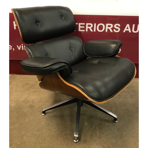 13 - A Charles and Ray Eames style simulated rosewood and black leather revolving lounge chair