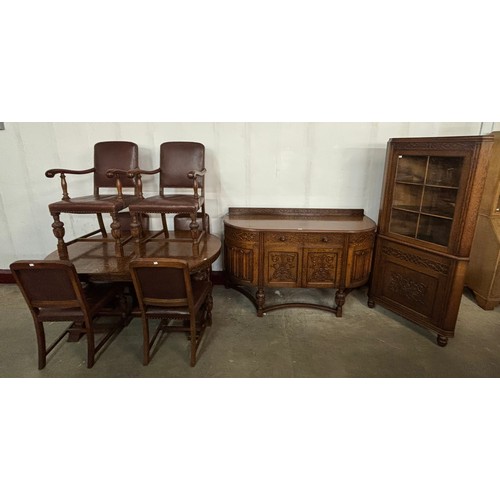 101 - A 17th Century style carved oak nine piece dining suite, comprising; extending dining table, six cha... 