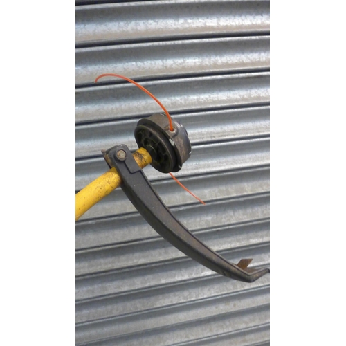 5209 - A Ryobi PLT2543Y petrol driven strimmer
