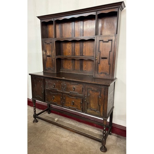 86 - An early 20th Century Jacobean Revival geometric moulded oak barleytwist dresser