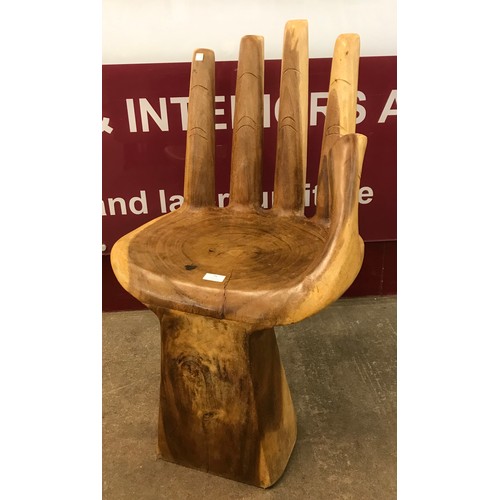 91 - A carved hardwood hand shaped chair