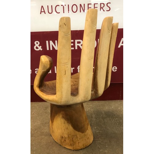 91 - A carved hardwood hand shaped chair