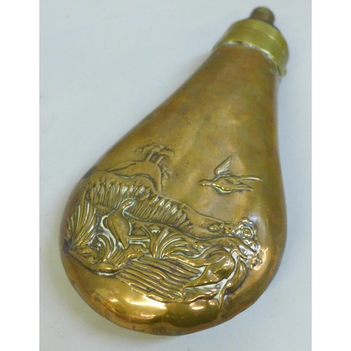 2038 - A gun powder flask with pheasant detail, a/f seam split