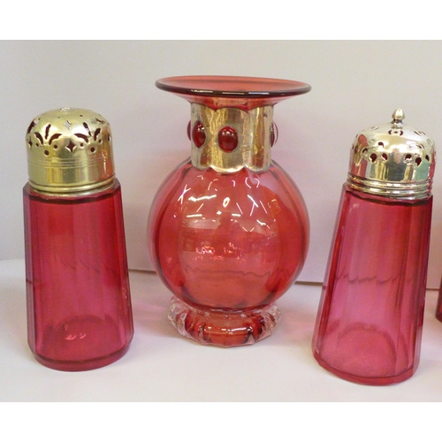 2102 - Cranberry glass; a vase with silver plate detail, a pot with lid and gilt detail, an Art Deco scent ... 