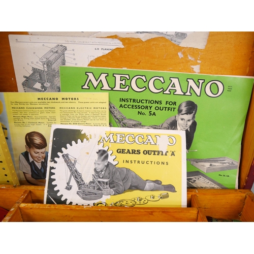 2224 - A collection of mid 20th century Meccano including catalogues and cased in a wooden box, including b... 