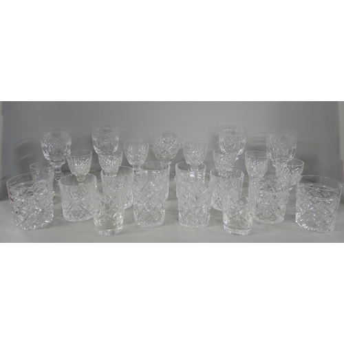 2228 - A collection of crystal glassware comprising sherry glasses, eight tumblers and wine glasses, variou... 