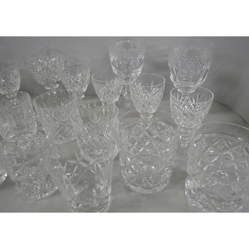 2228 - A collection of crystal glassware comprising sherry glasses, eight tumblers and wine glasses, variou... 