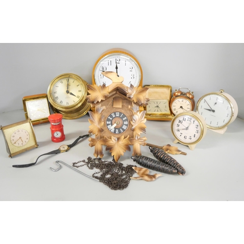 2231 - A box of nine clocks including wooden and brass examples, travel clocks and a cuckoo clock **PLEASE ... 