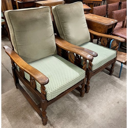 166 - A pair of early 20th Century oak barleytwist reclining armchairs