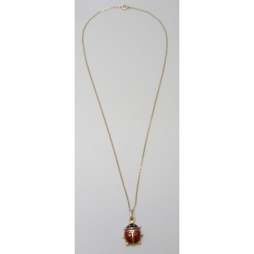 7015 - An 18ct gold & enamelled ladybird pendant, 1.5g, on a 9ct gold chain, 0.6g